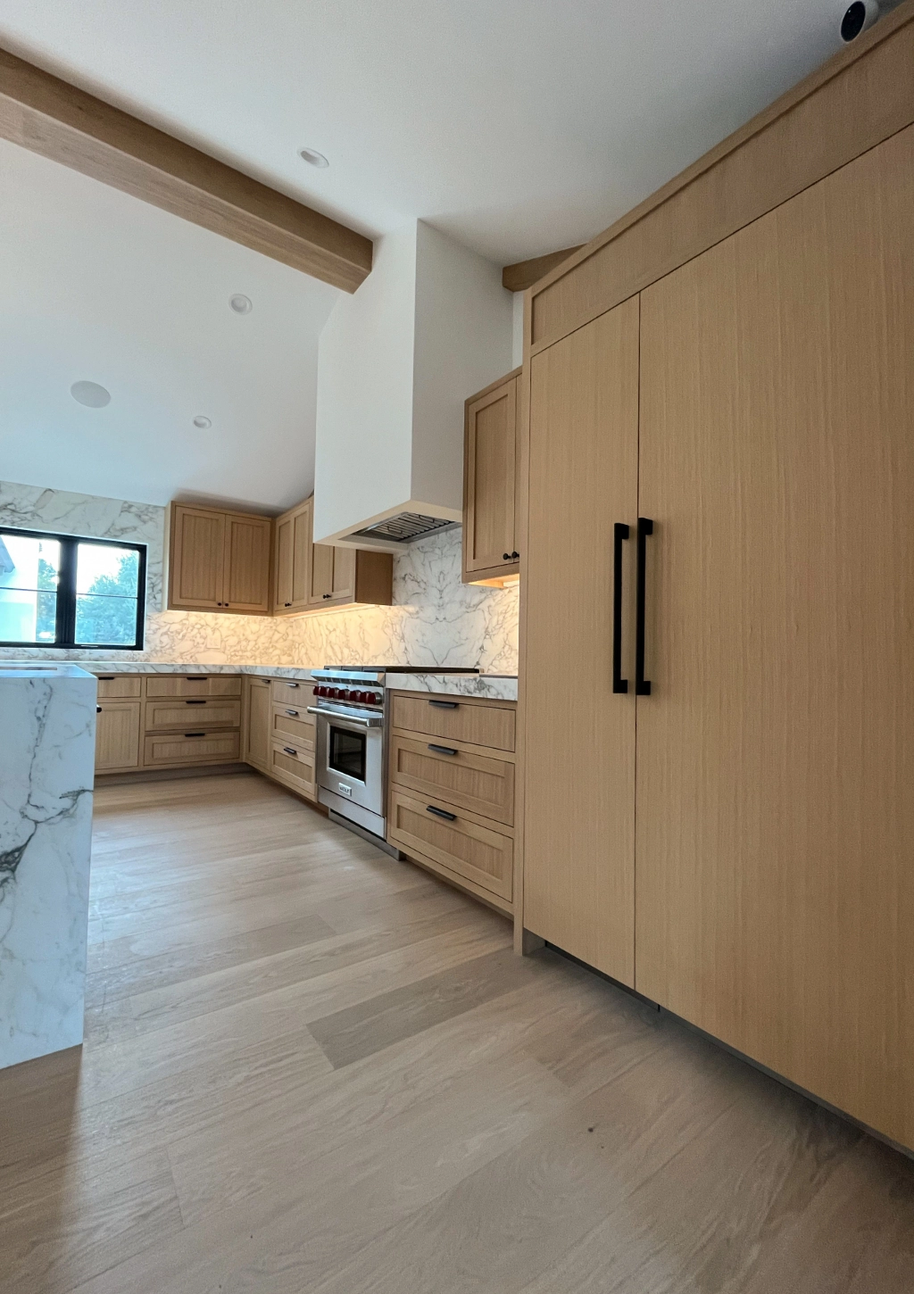 A modern kitchen remodel with wooden features.